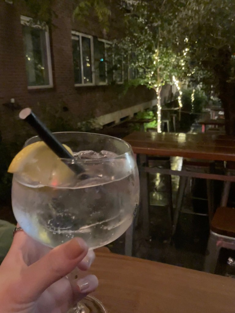 Enjoying a drink in the courtyard of my Amsterdam hostel